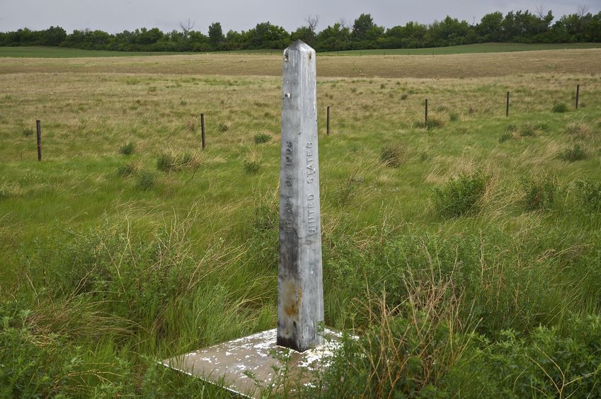 The U.S.-Canada border marker, just east of the confluence point, at [48.9986,-111.9953]