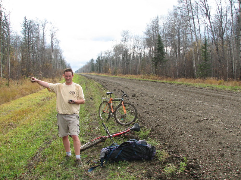 Greg standing on the gravel/mud road with the bikes we walked there.
