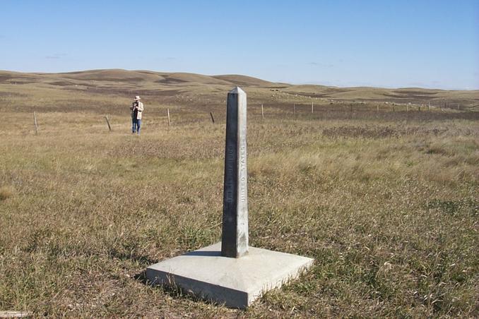 View northeast showing border monument and Alan standing at the confluence.