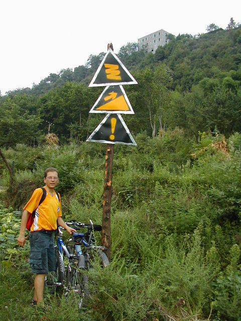 Signs of times. Winding, uphill, and difficult.  Baimiao sits on top of the ridge in the background