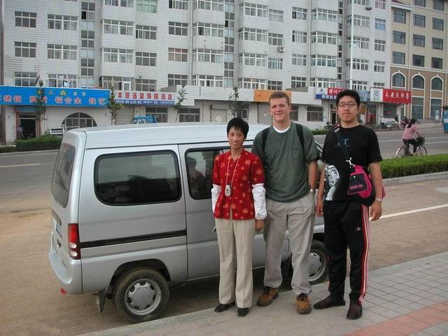 Minivan taxi we rode in, the intrepid driver, myself and my new Chinese friend Pink