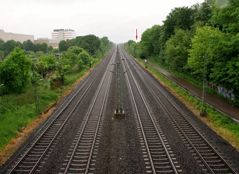 The railway from the bridge. The point is below the arrow, just behind the trees