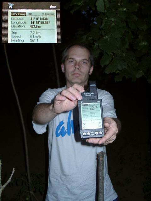 Roman holding the GPS in the twilight