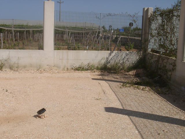 Gravel surface in a partly finished compound with wineyard
