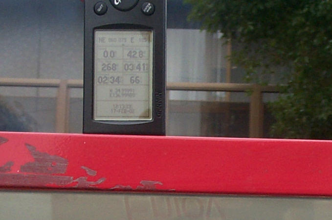 Shows the detail of the GPS-V on top of a Coca-Cola vending machine. Clearly shows the Latitude and Longitude to be N34.99991 and E136.99989.
