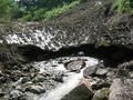 #4: Snow in summer?!  Stream carves a cave through one of winter's avalanches.