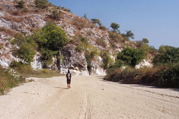 Ma Htar Htar Thu walking back on the dry riverbed