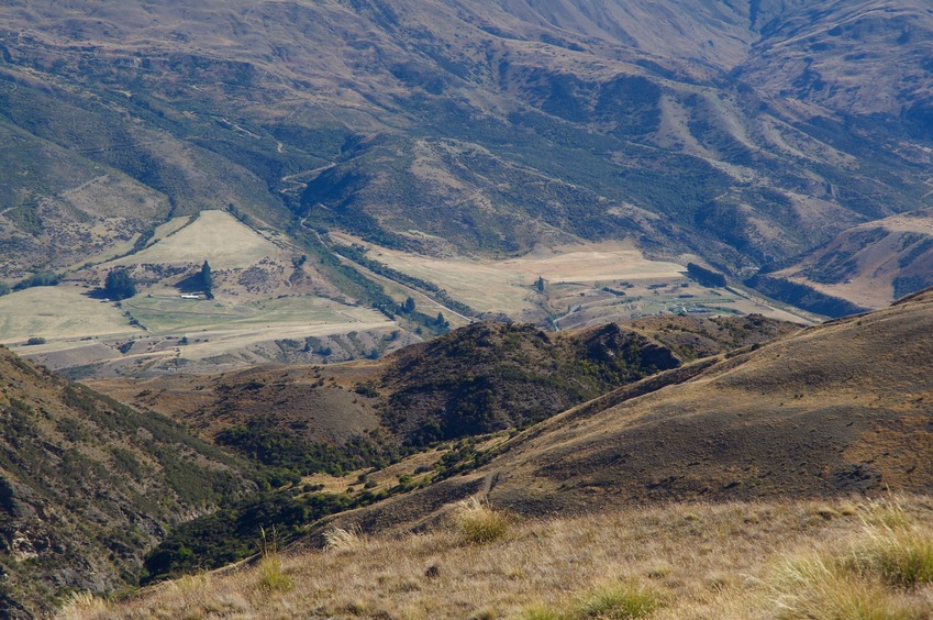 A telephoto view down to Highway 6 and the small farming settlement of Gibbston