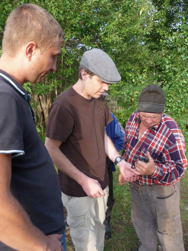 Back in the hamlet trying to explain the concepts of GPS and 'confluence point' to the villagers.  Evgeny on left.