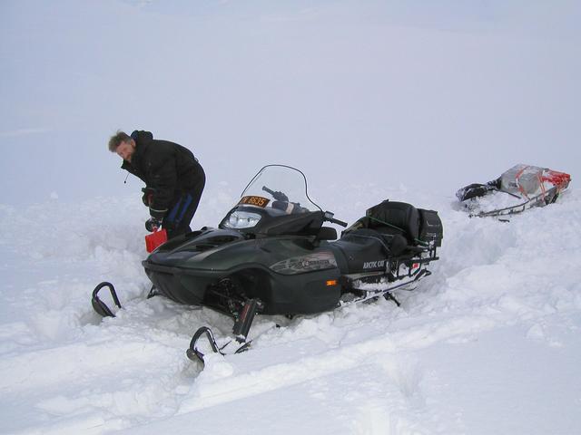 Stuck in deep snow: Digging out the snowmobile