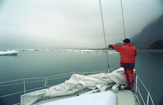 Imram, arctic sailboat, negotiating icebergs in Svalbard