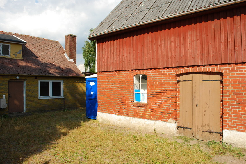 House with toilet seen from parking area