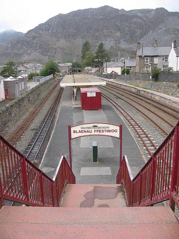 Blaenau Ffestiniog railway station with both narrow guage and regular tracks.  Moelwyn Mountains in the background.