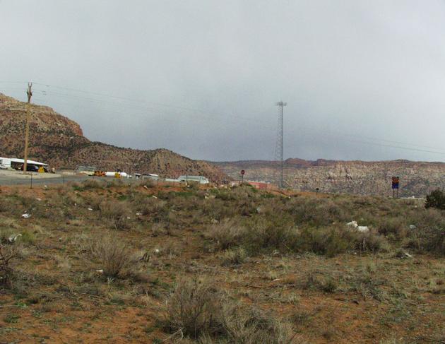 looking east. the border between Utah and Arizona is the blue and yellow sign in the right-hand side of the photo