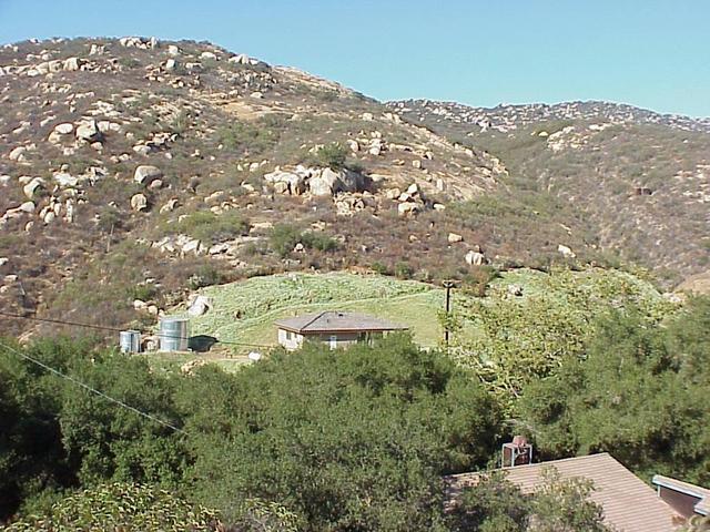 Confluence site from the nearest road.  The confluence is uphill from the new guest house in the center of the photograph.