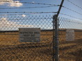 #7: Restricted area notices on the chain link fence
