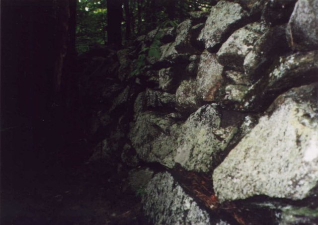 A tall stone wall at the confluence.