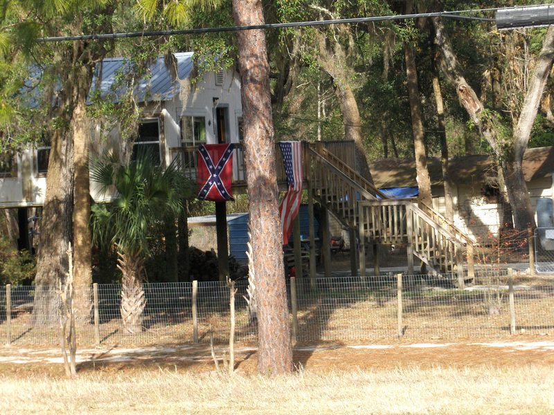 The US and Confederate Flags in a house nearby