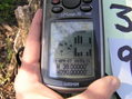 #6: GPS reading at the confluence, a bit tricky to obtain under the trees.