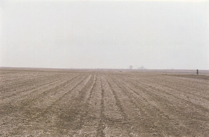 Looking east, the automobile is visible parked about 0.3 miles distant.