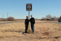 #10: Wind blown confluence hunters with historic Route 66 sign ... and friendly local cat 