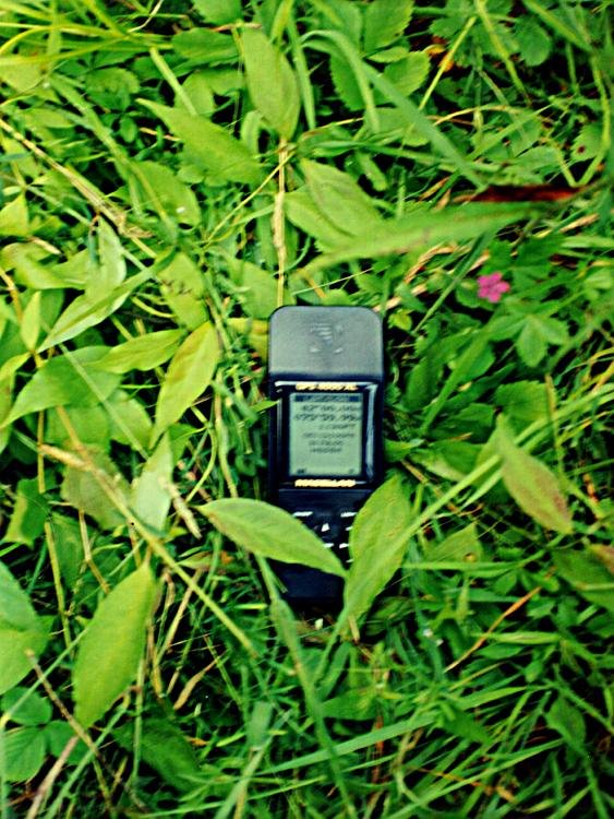 Shaken camera picture of GPS on ground at confluence