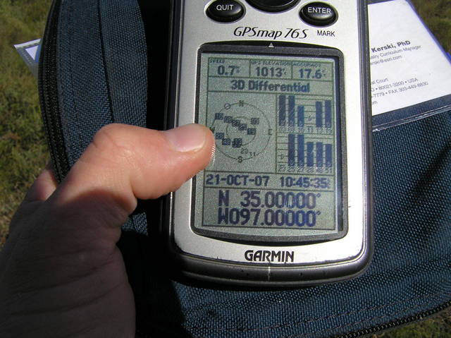 GPS reading at the confluence in the bright sunlight.