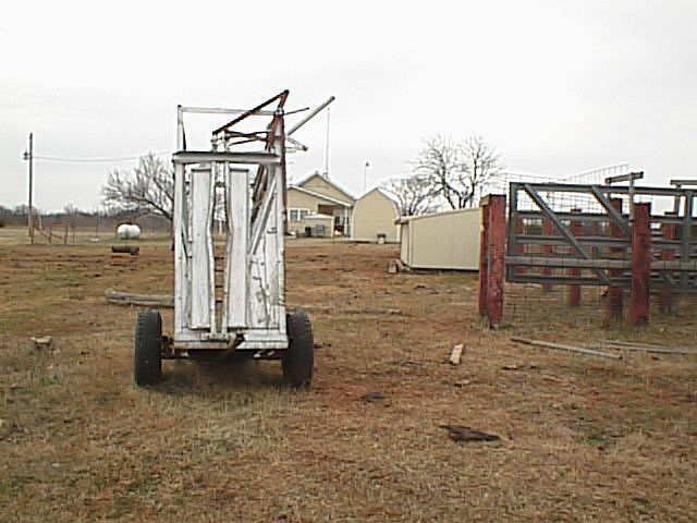 Farm equipment with the owner's house in the background