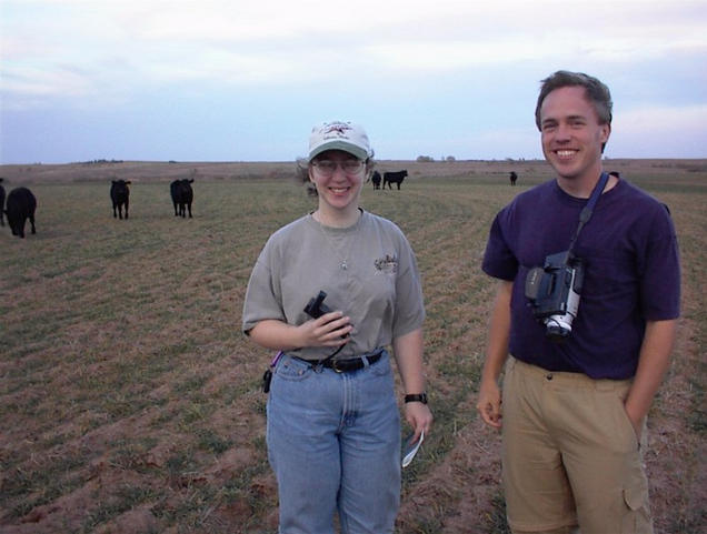 Daphne and Jim at the confluence, with the cows edging closer