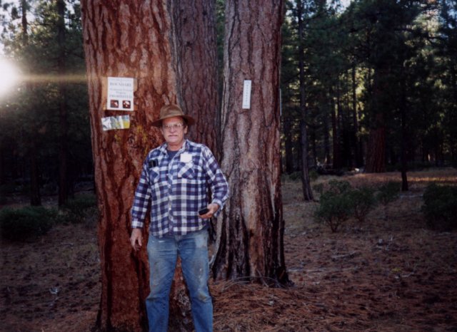 I am standing near the Crater Lake National Park boundary sign at N43 W122