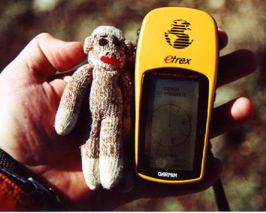 Chango the Sock Monkey verifies the correct coordinates on the GPS