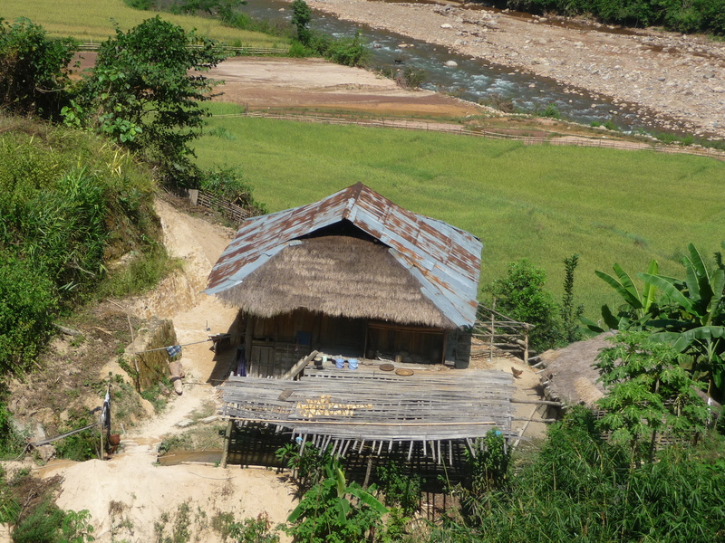 Typical house on the way to the confluence with sustenance of dried river fish and rice fields. 