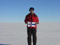 #8: Me with flag of Finland and part of Heimefrontfjella at horizon