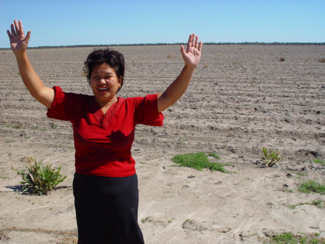 Liza Tully celebrates the find against the backdrop of the barren field