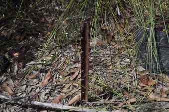 #1: The confluence point is marked by this heavily-rusted metal post