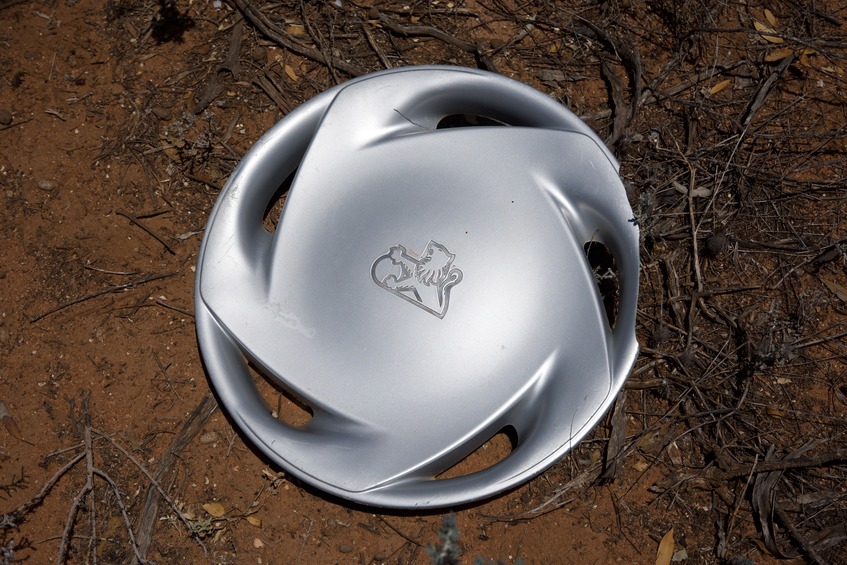 A hub cap from a Holden car, laying very close to the point