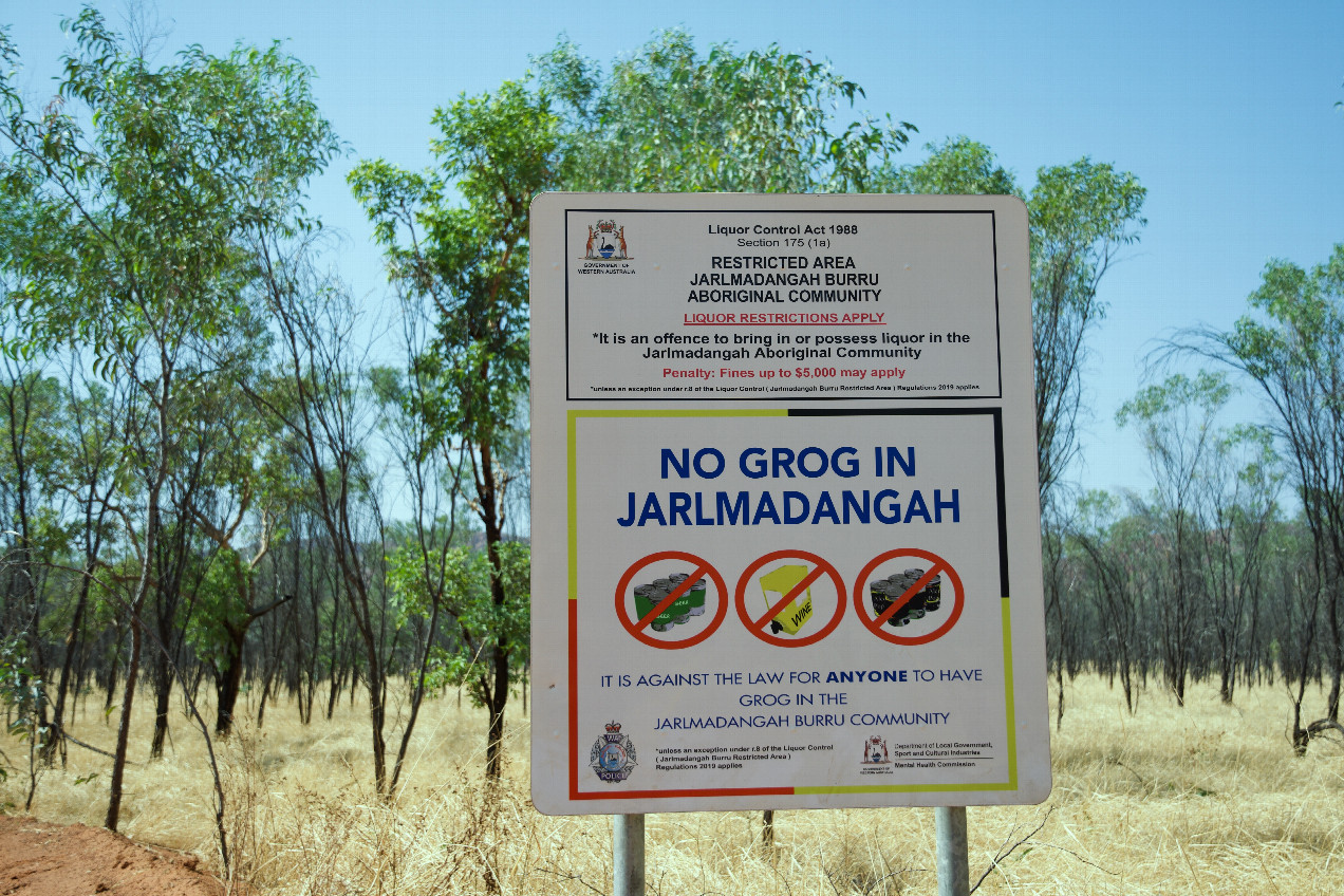 A sign on the nearby road, noting that alcohol is banned in the Aboriginal community