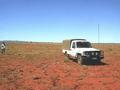 #3: Our trusty 4WD and Robin standing at the confluence. Old cattle yards in the middle-distance.