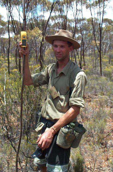 Peter holds the stick to mark the "spot" with GPS