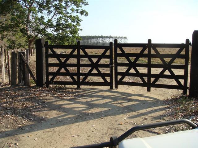 Porteira trancada. Gate closed with padlock.