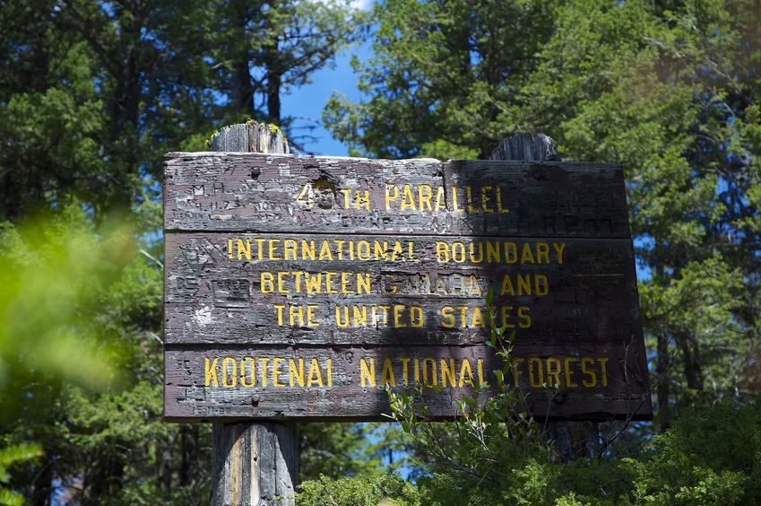 The sign at Burma Road's last zig-zag, noting the international Border.  (This is 0.3 miles west of the confluence point.)