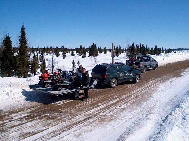 Loading snowmobiles near the bridge at MishwopTurn on South Feeder, Paradise River, Labrador.