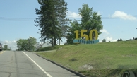 #8: #08 entrance of Sainte-Perpètue with 150 year anniversary sign