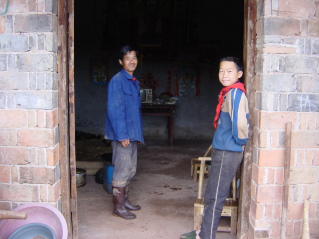 Mr Chen and his son at the confluence, the front door of their house