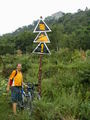 #8: Signs of times. Winding, uphill, and difficult.  Baimiao sits on top of the ridge in the background