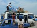 #4: Loading roof of Liu'an-to-Wulong bus with bottled water prior to departure.