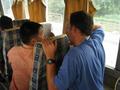 #7: Corrado showing some locals on the bus our map.