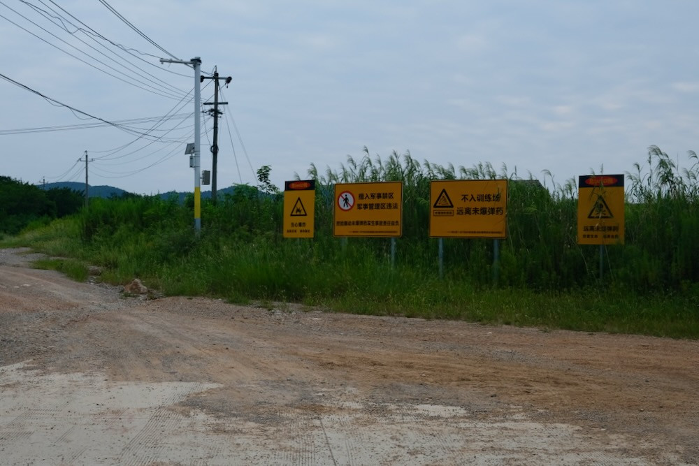 Some of the signs at the intersection where we stopped, facing north-west towards the confluence point.