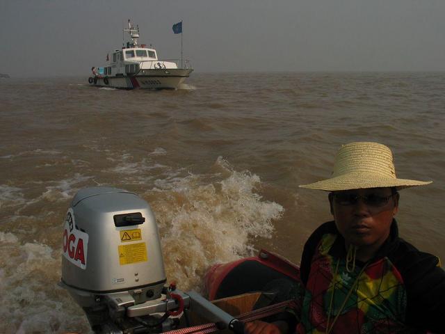 View northwest, upstream. MSA boat and our raft pilot, He Jian Qiang.