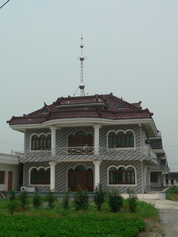 The famous Oriental Pearl Tower atop a local house